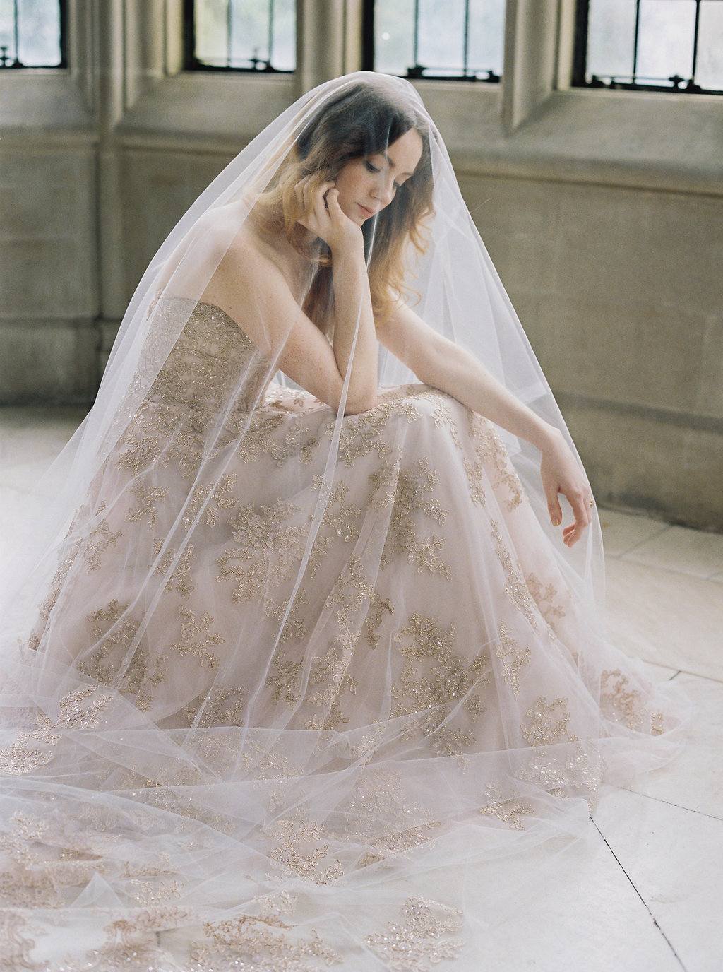 Bride in blush colored wedding gown and veil