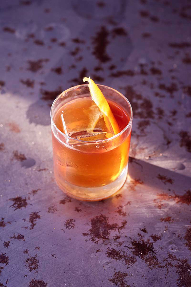 saint charles cocktail with orange peel garnish