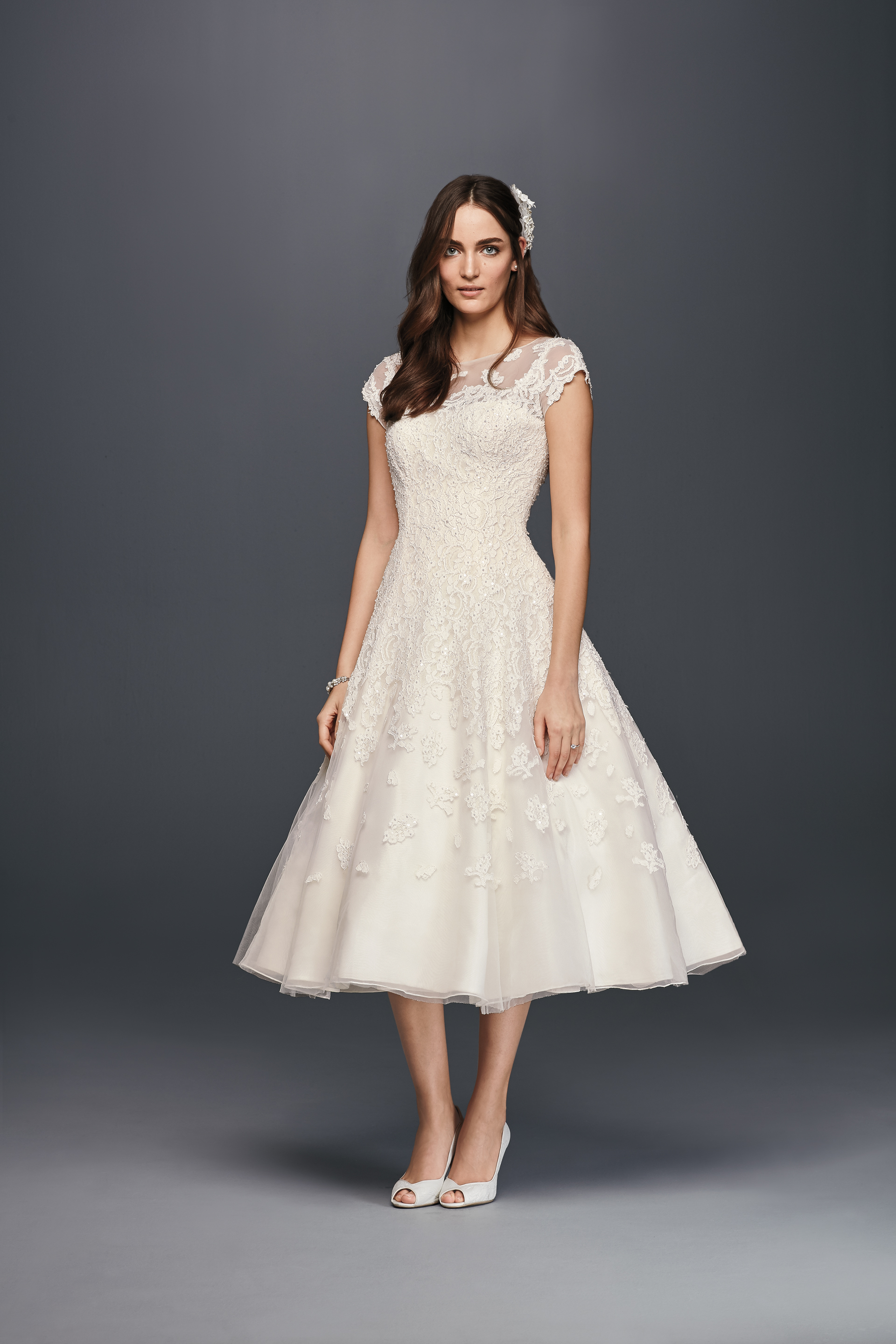 Call Sleeve Illusion Tea Length Wedding Dress with a neckline similar to Pippa Middleton's wedding dress. See more Pippa inspired wedding dresses on the David's Bridal blog.