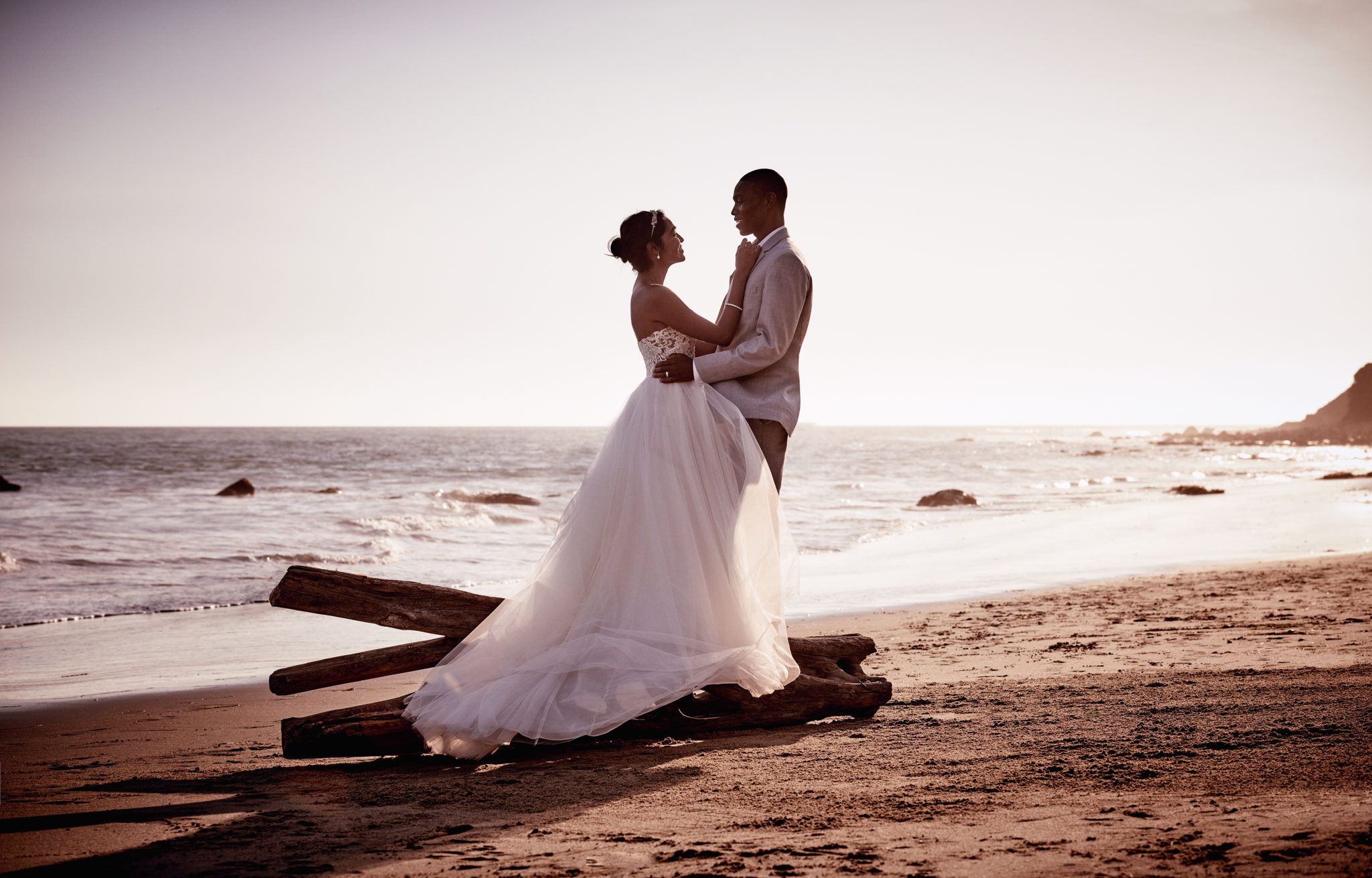 Bride and groom on the beach at sunset