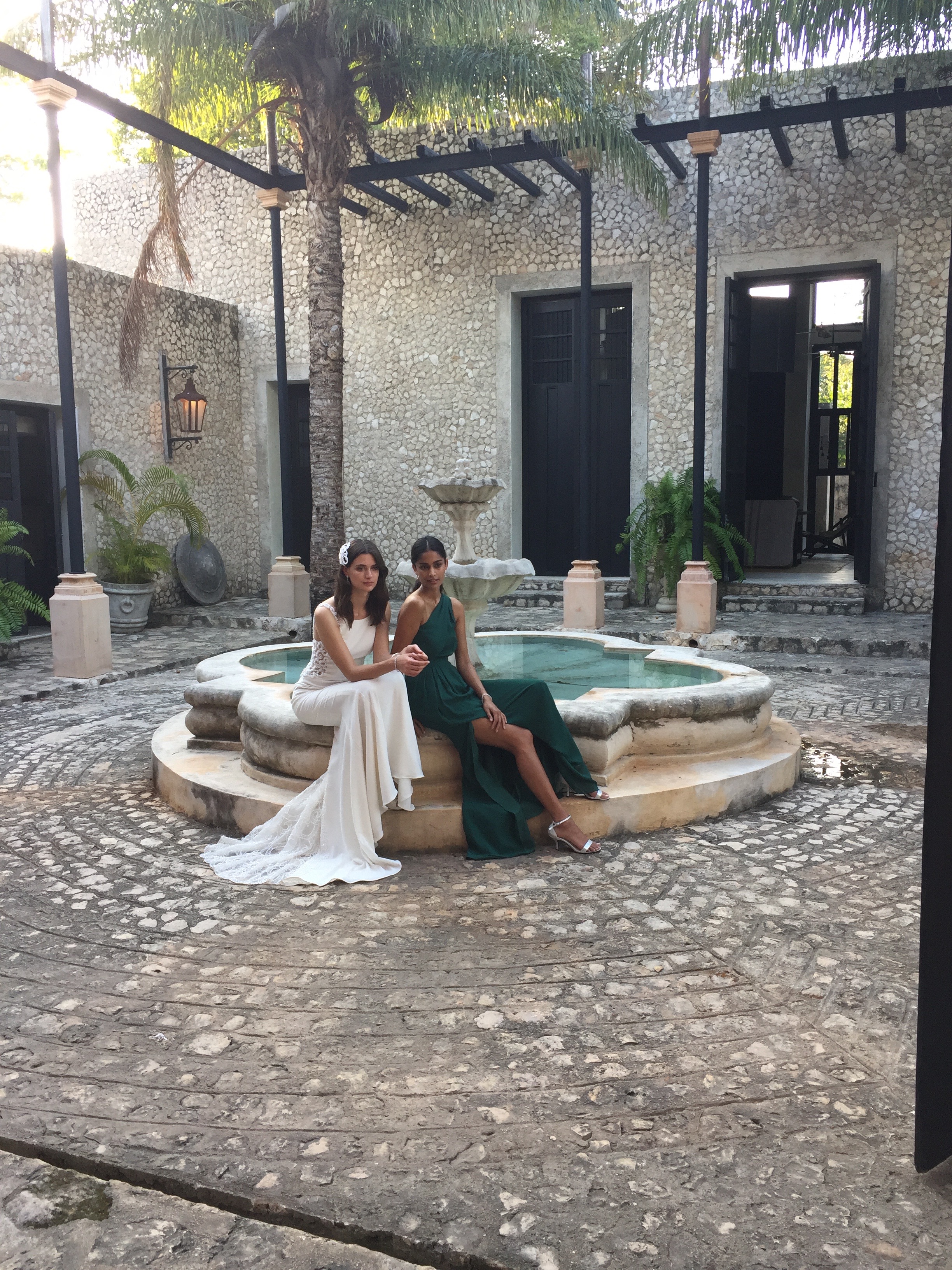 A stylish bride in Galina Signature and her bridesmaid in one of the hottest colors of the season: green. See more on The David's Bridal blog - www.davidsbridal.com/blog.