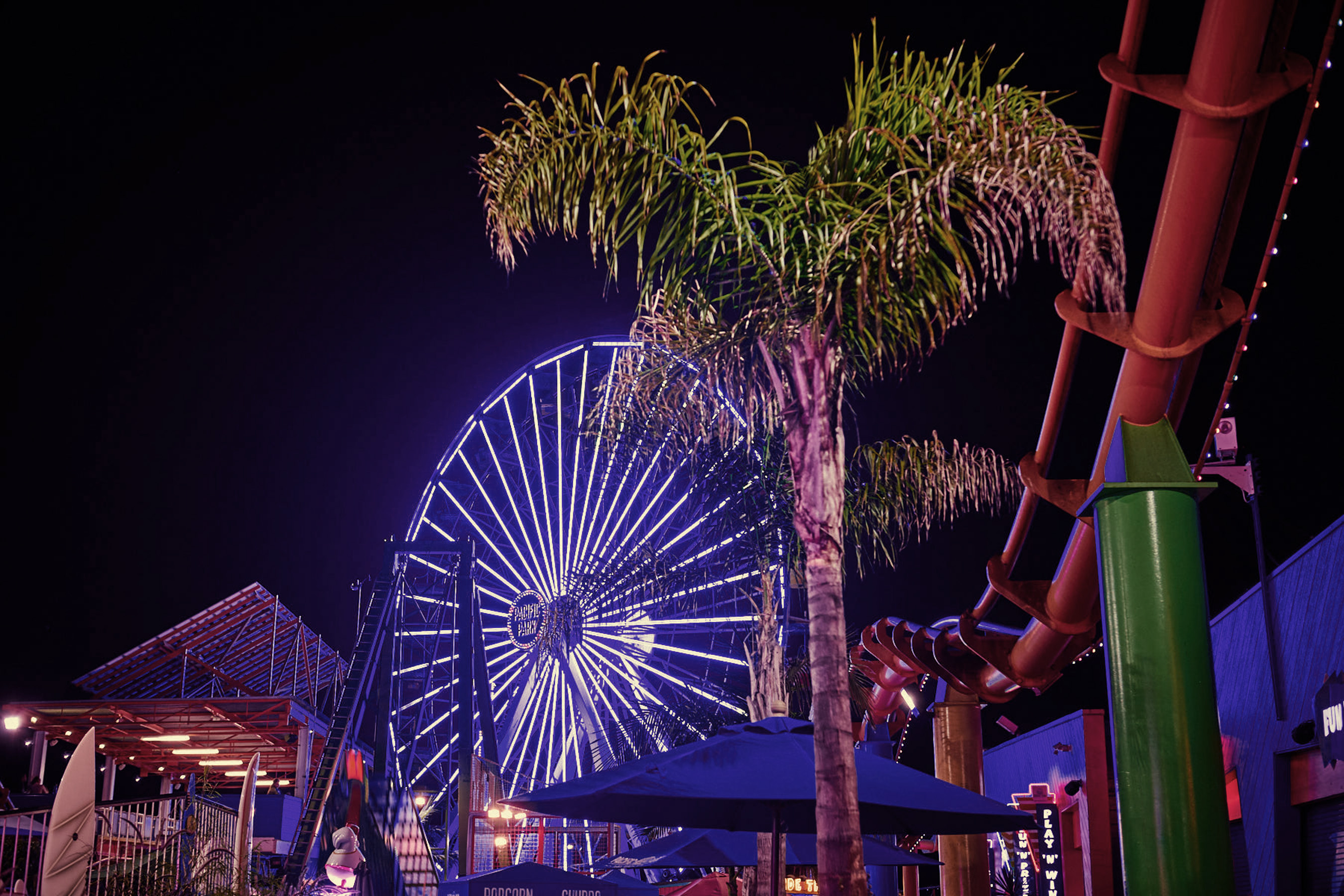 The iconic Ferris wheel at Santa Monica Pier lights up the night. 