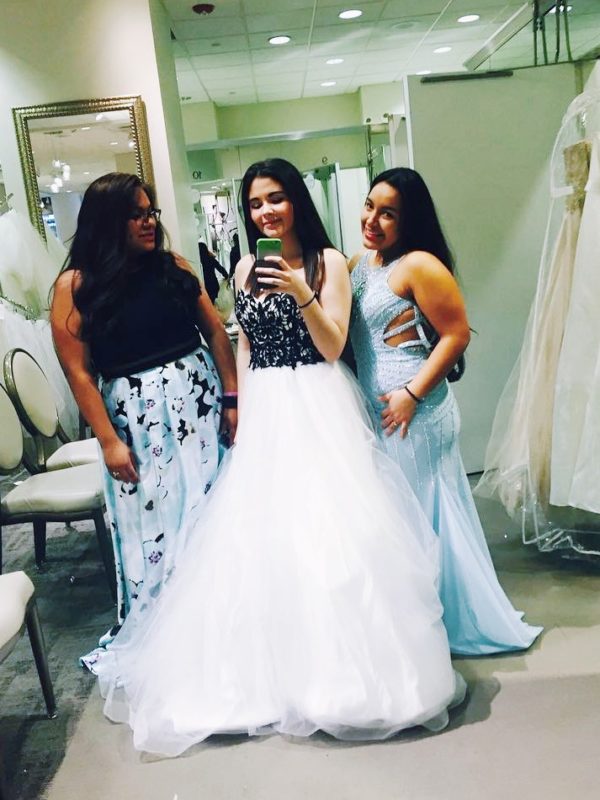Mirror photo of three girls prom dress shopping