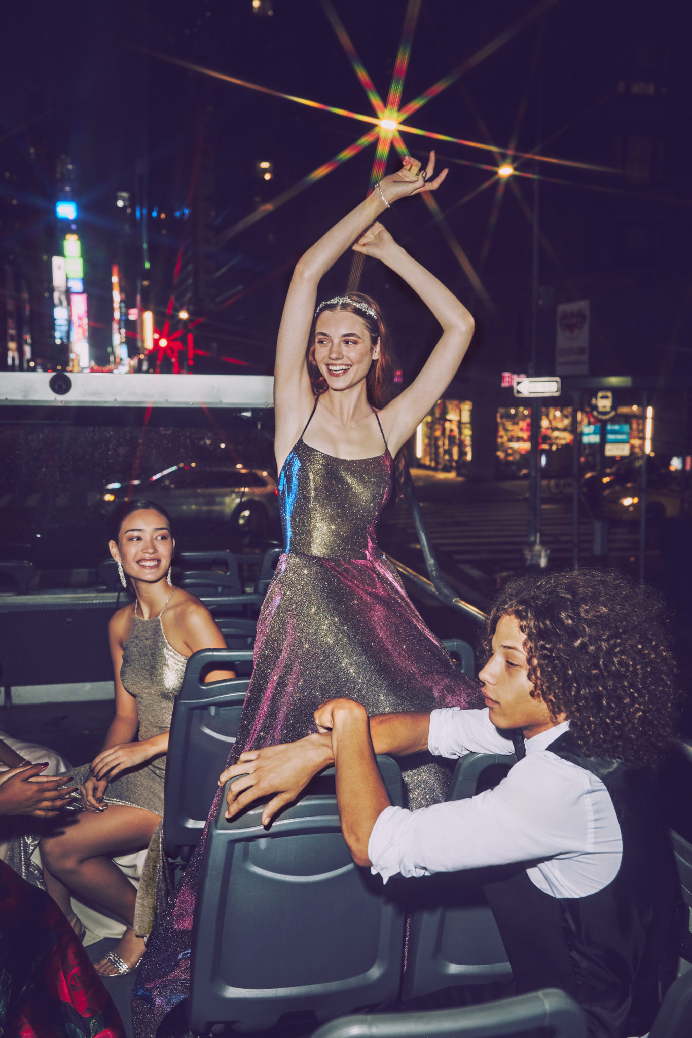 Girl in multicolored ball gown prom dress on bus in New York City