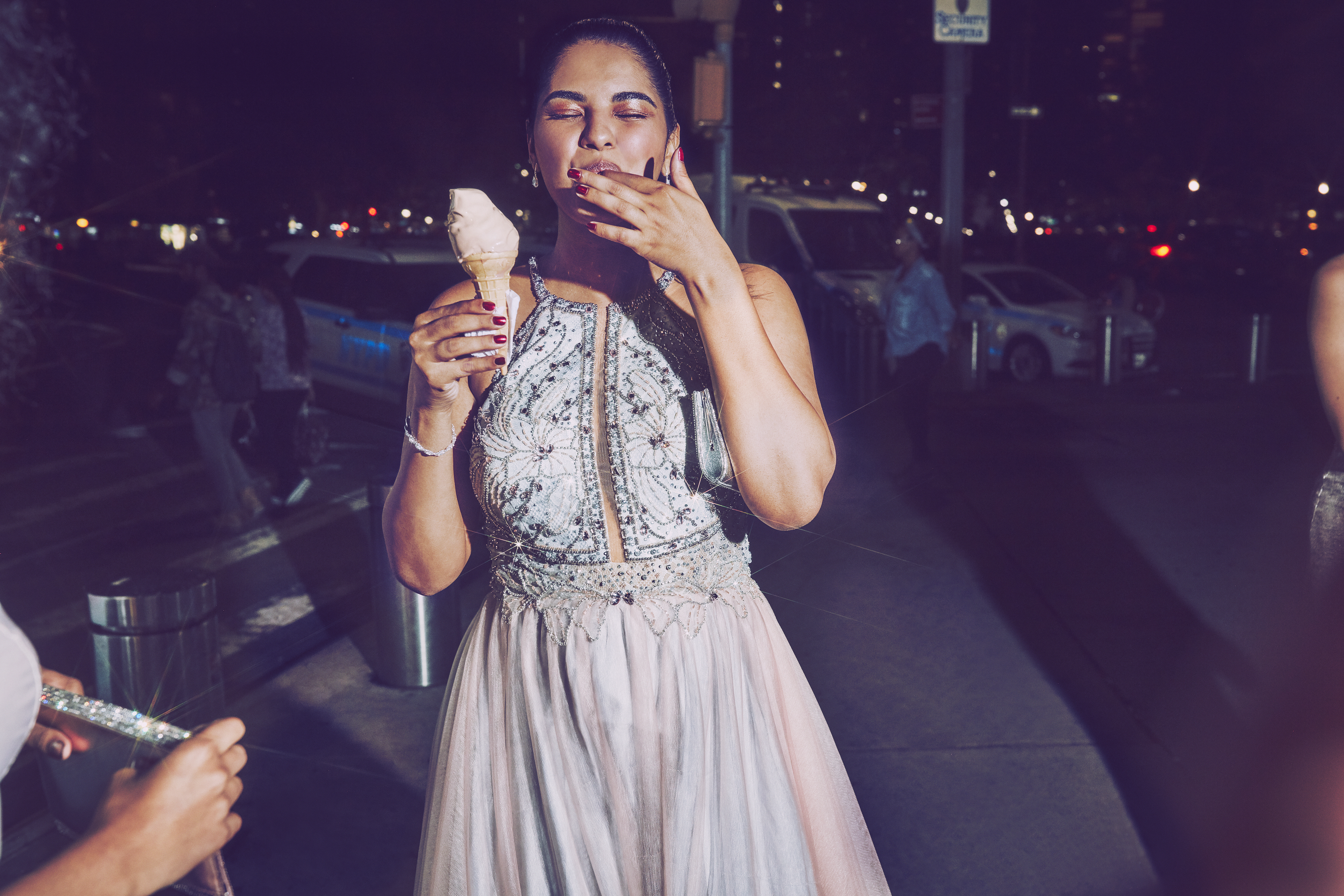 Girl eating ice cream in crystal long prom dress