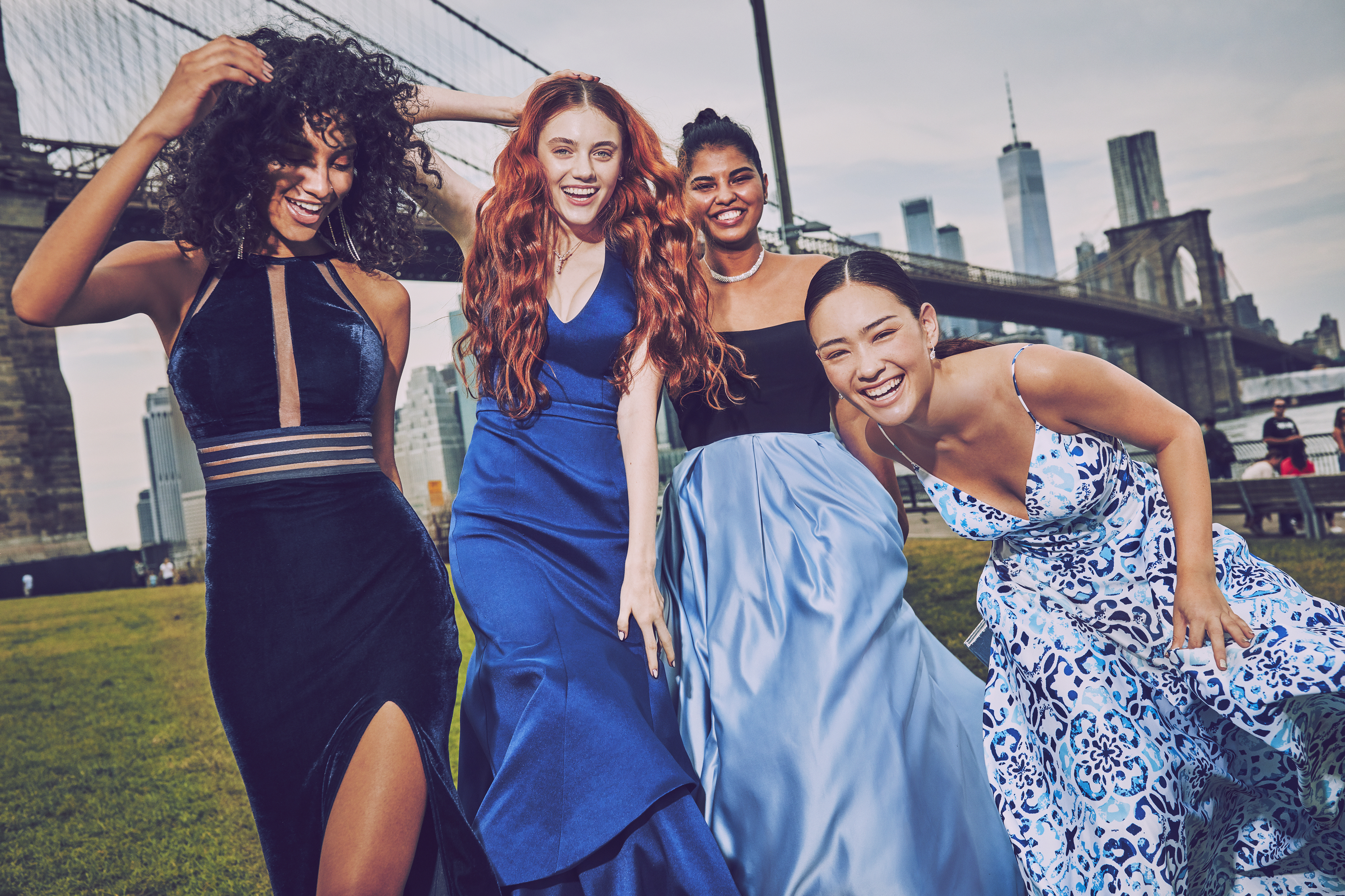 Girls in long blue prom dresses in a park