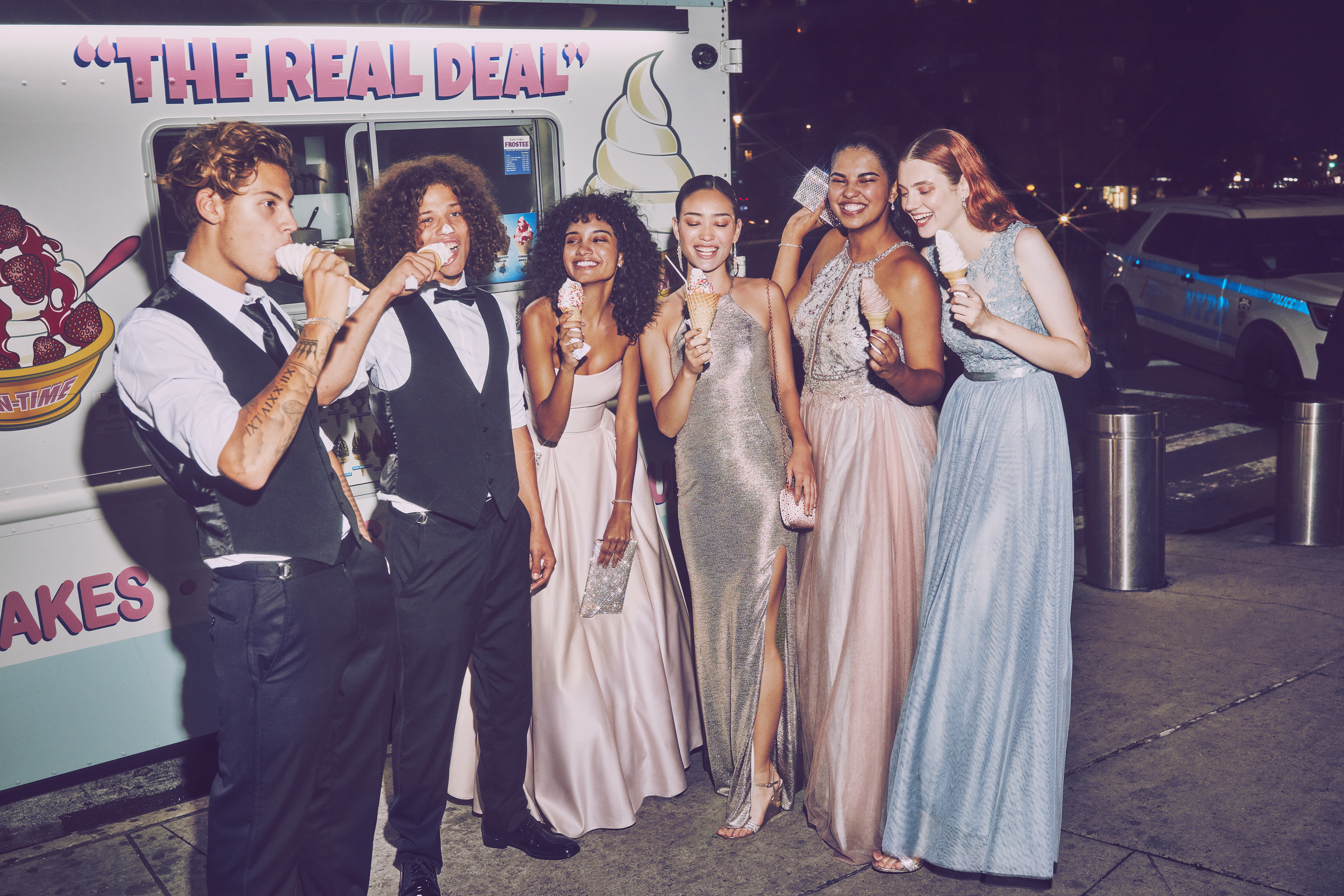 High School girls and boys eating ice cream in suits and long prom dresses