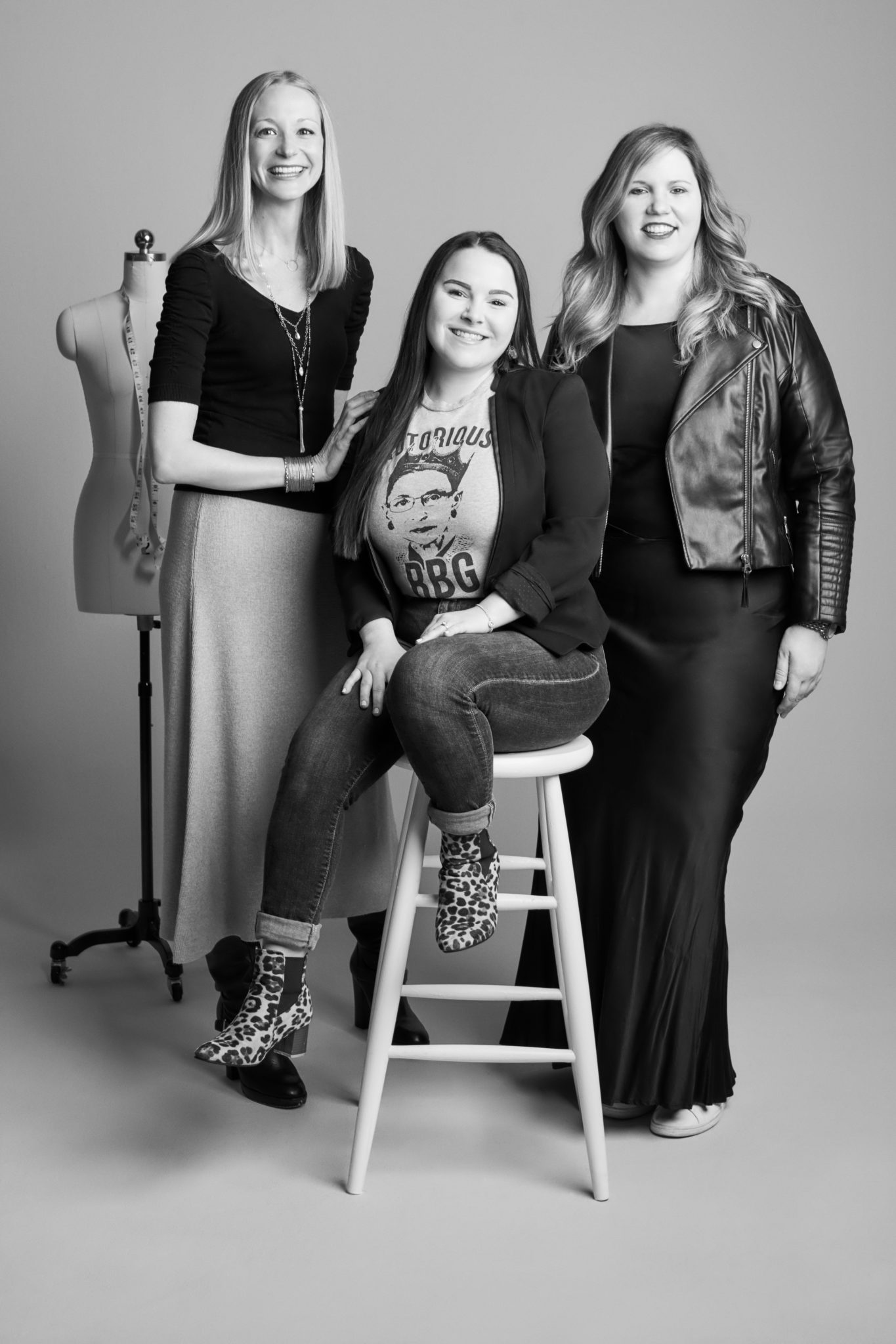 Three women from David's Bridal's merchandising team in a photo studio setting