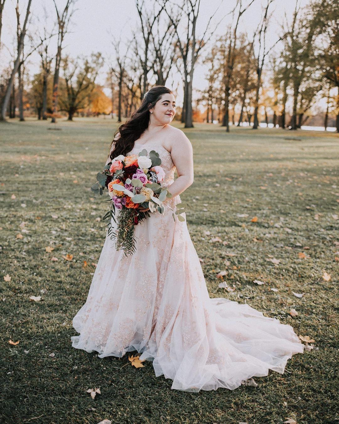 Bride in a strapless blush colored tulle ball gown 