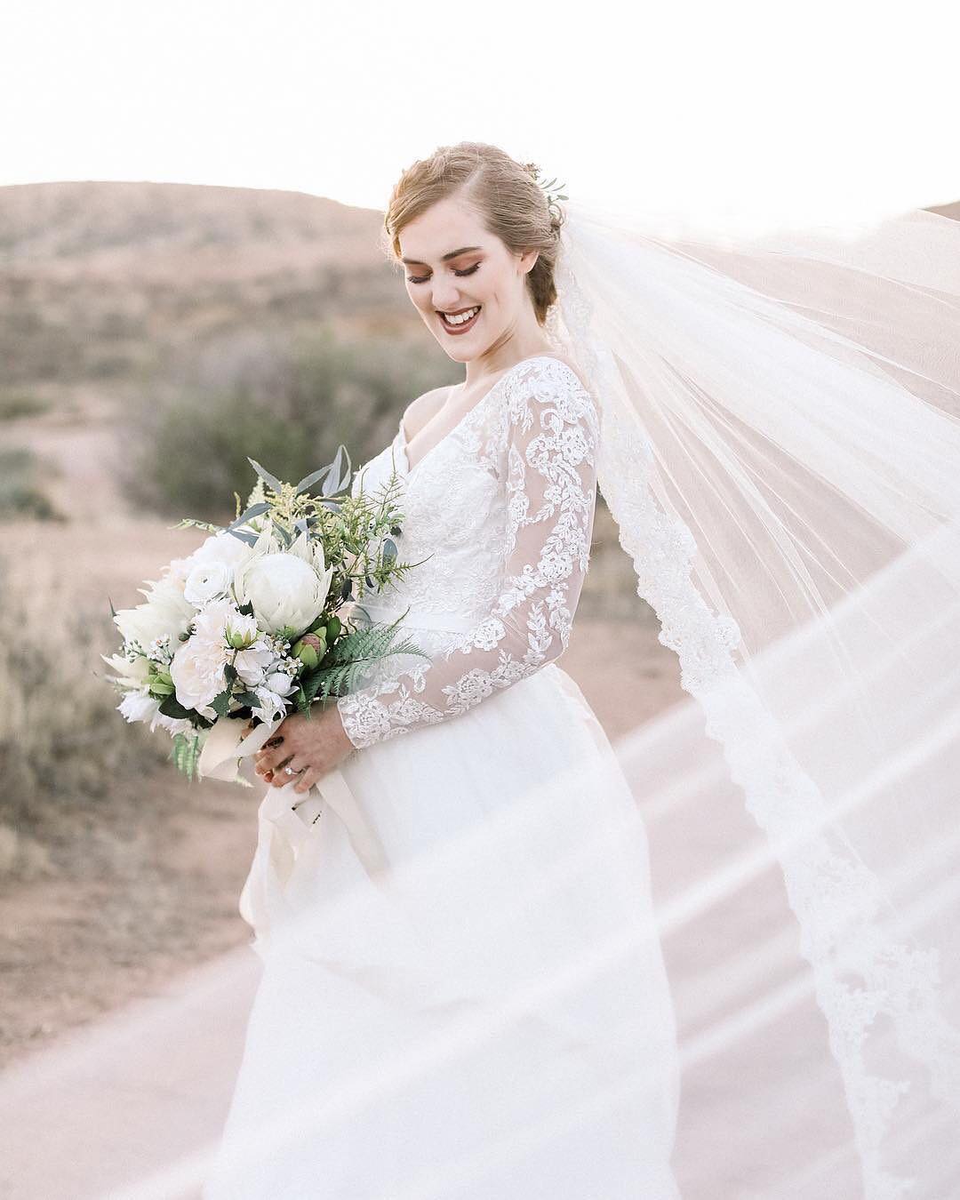 Bride wearing a lace trim cathedral length veil | | Insta-Worthy Veils