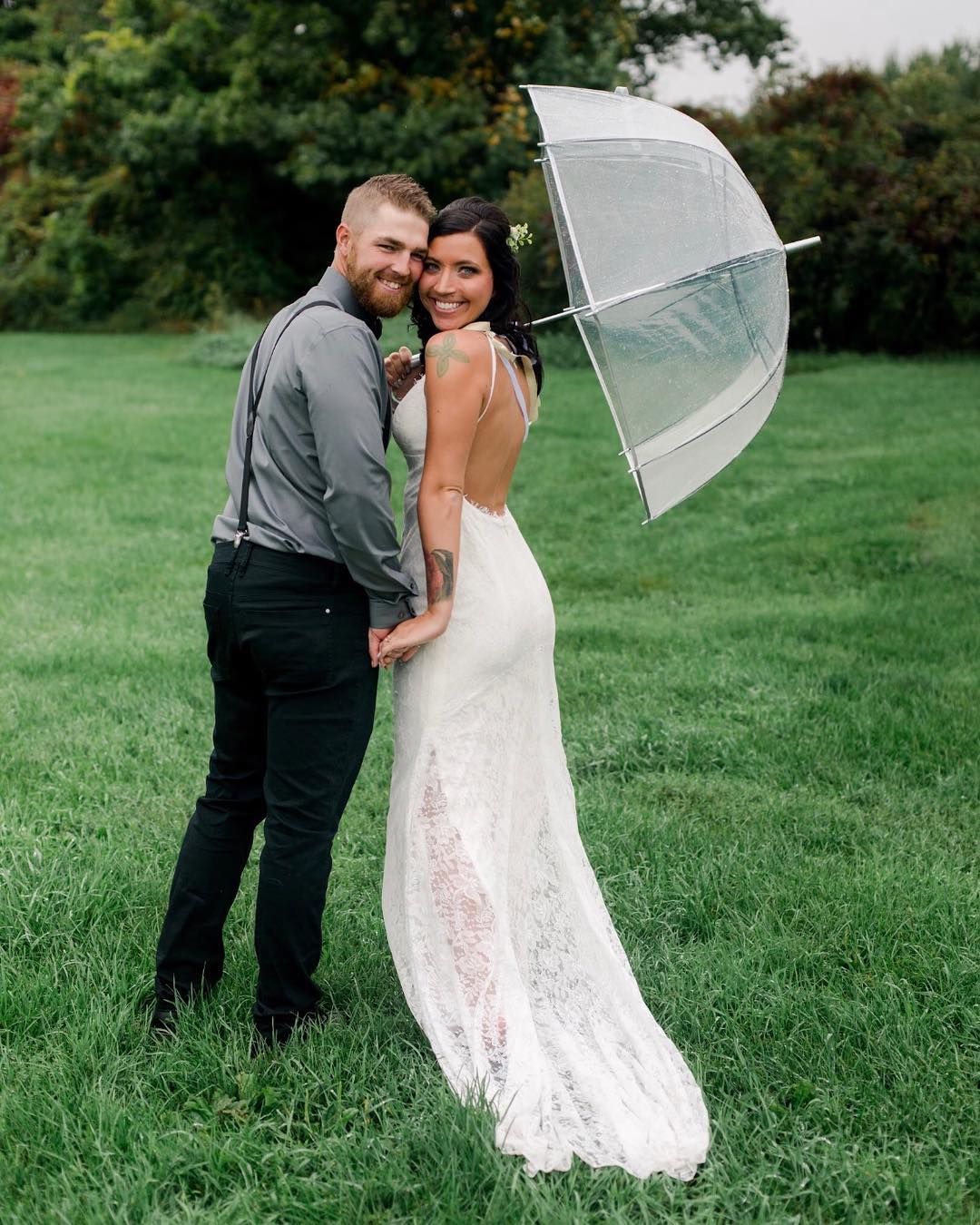 Man and woman smiling with umbrella