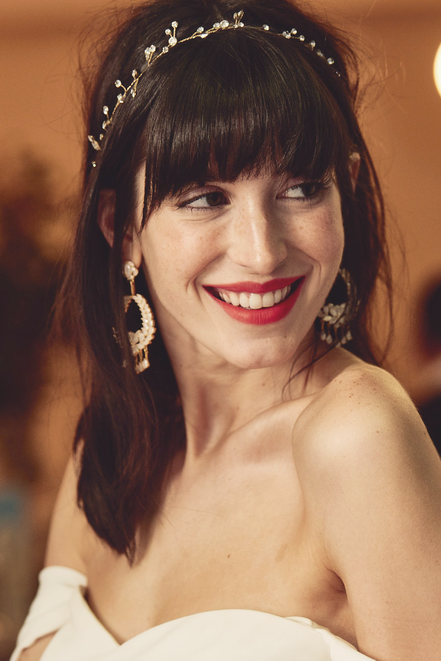 Smiling bride in off-the-shoulder dress and wearing red lipstick