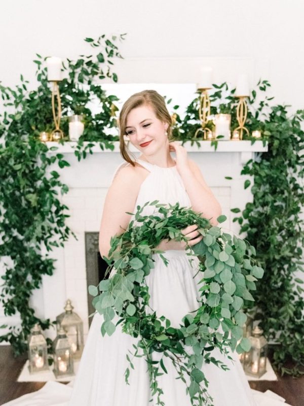 Bride in white dress holding greenery wreath or hoop bouquet | Nontraditional Wedding Bouquet Ideas
