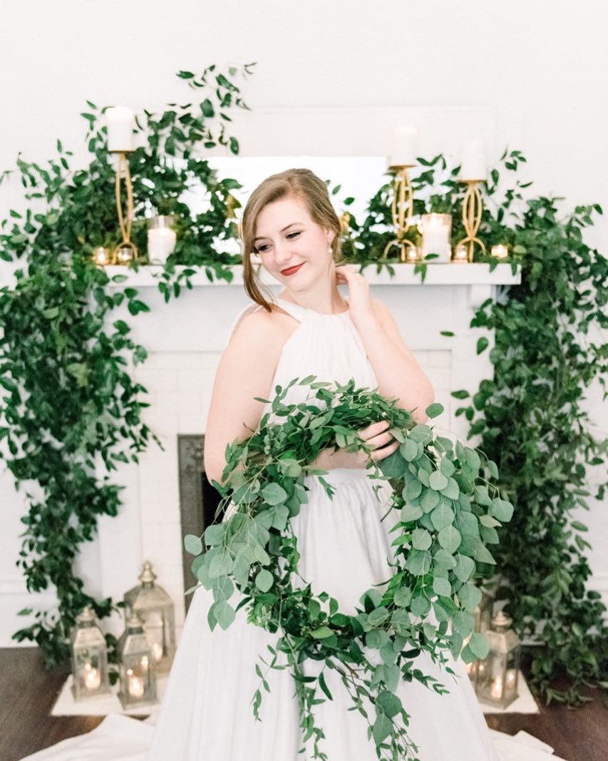 Bride in white dress holding greenery wreath or hoop bouquet | Nontraditional Wedding Bouquet Ideas