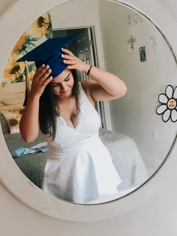 Girl in graduation cap and short white graduation dresses for 2019
