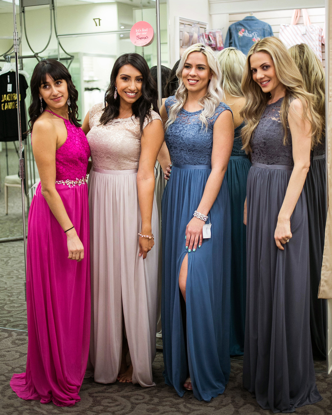 Four bridesmaids in long lace dresses shopping in David's Bridal store