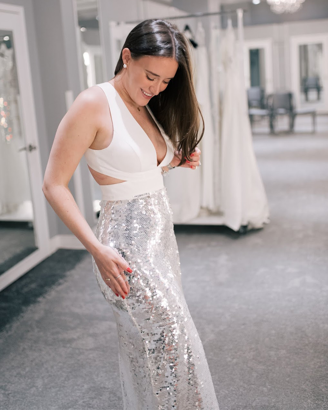 Bride-to-be in long dress with sequin skirt and bodice cutouts | Shopping for after-party dresses at David's Bridal