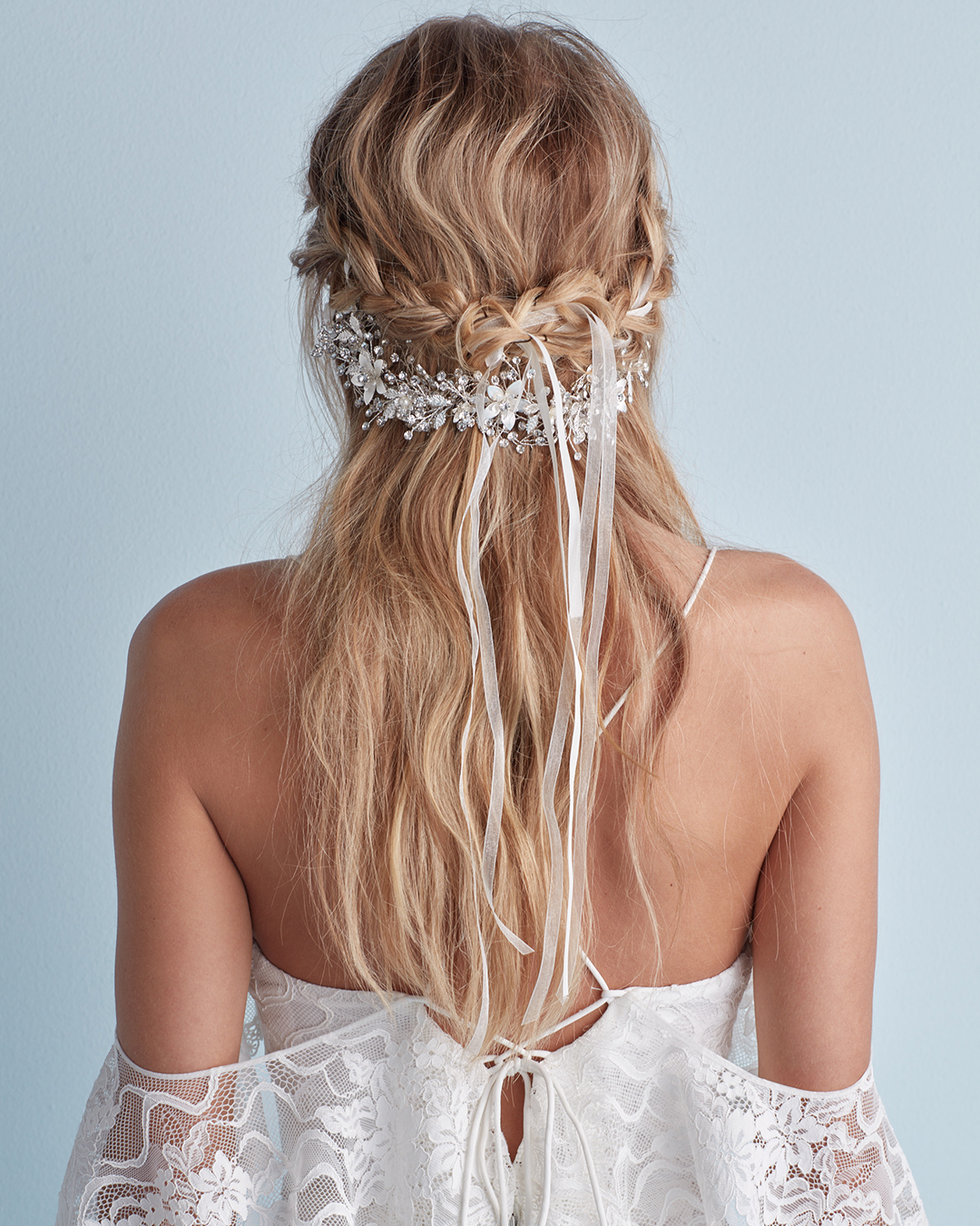 Wedding hairstyle with braid and crystal headband in half-up style