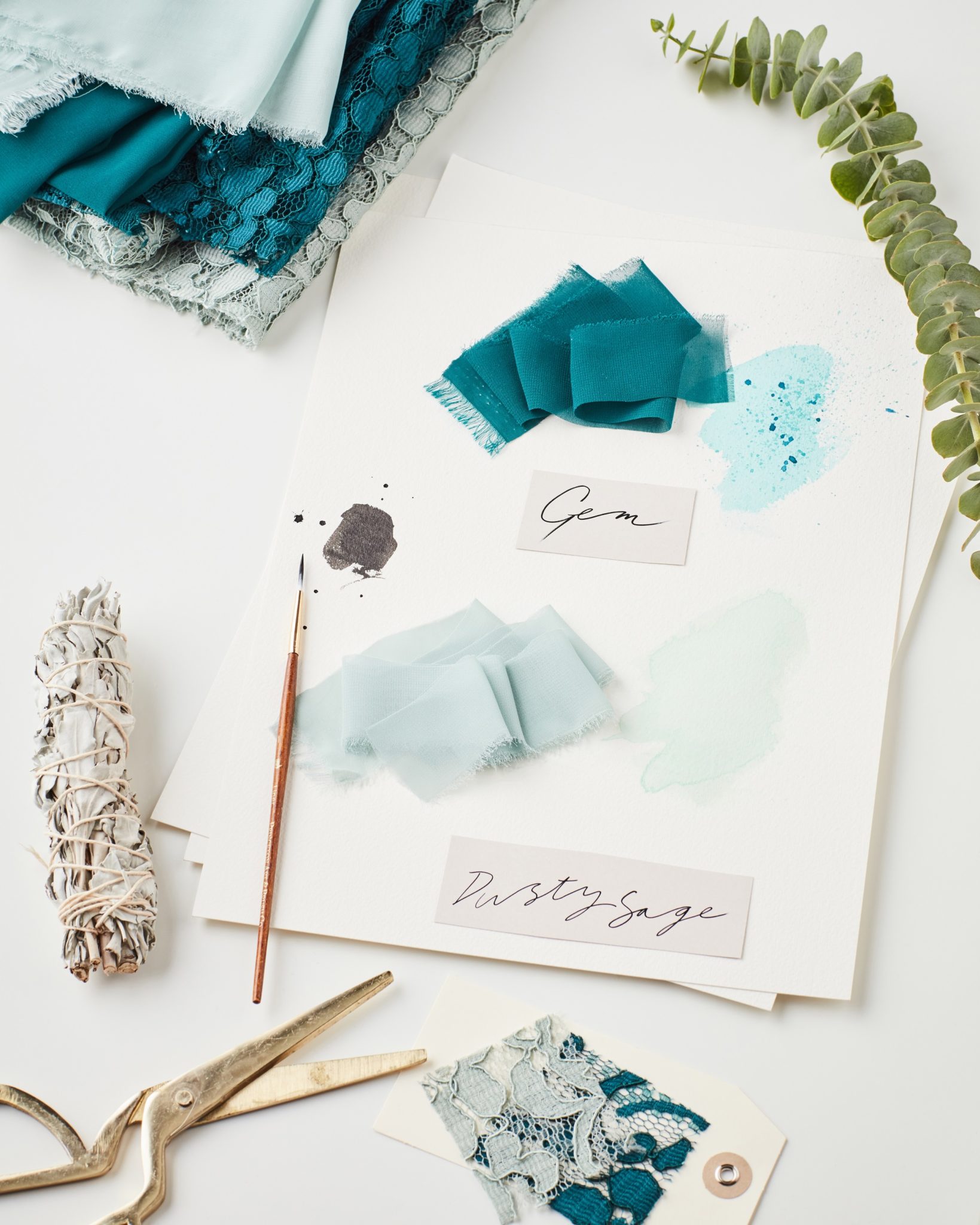 Green bridesmaid color swatches on design table