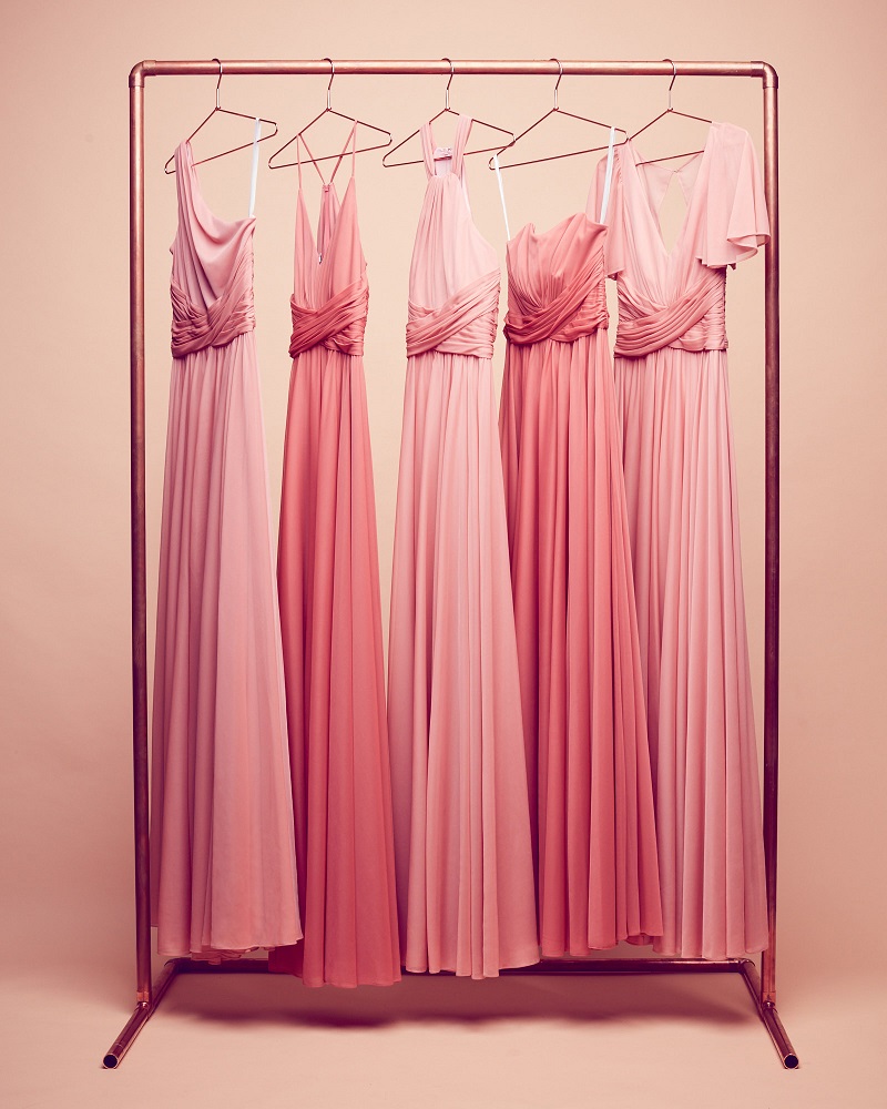 Coral dresses hanging on a rack