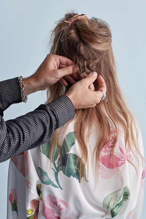 Hair stylist pinning bobby pins in hair