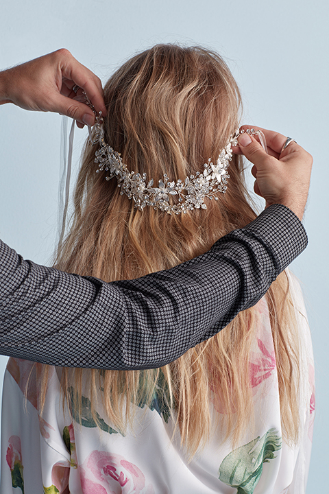 Hair stylist holding crystal belt up to hair