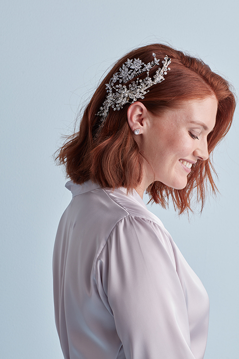 Bride smiling with side swept short hairstyle with hair accessory