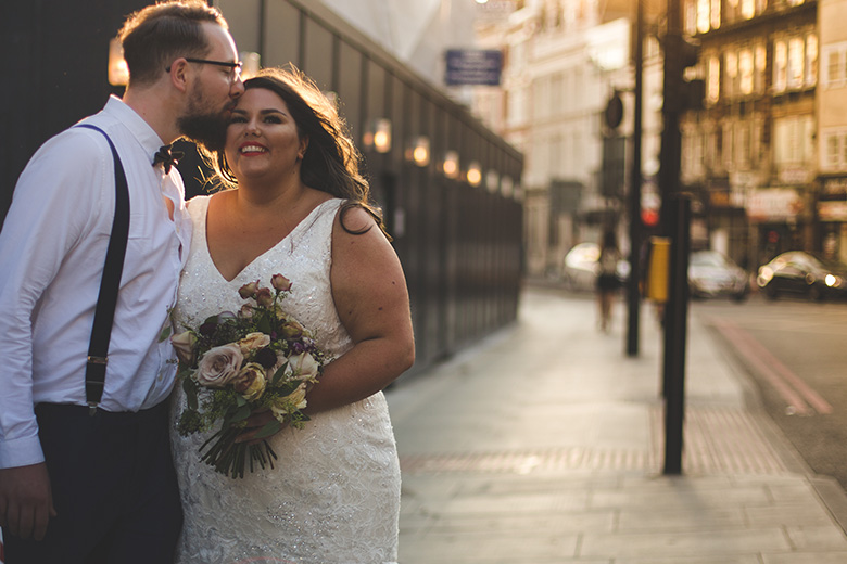 Bride and Groom embracing at sunset