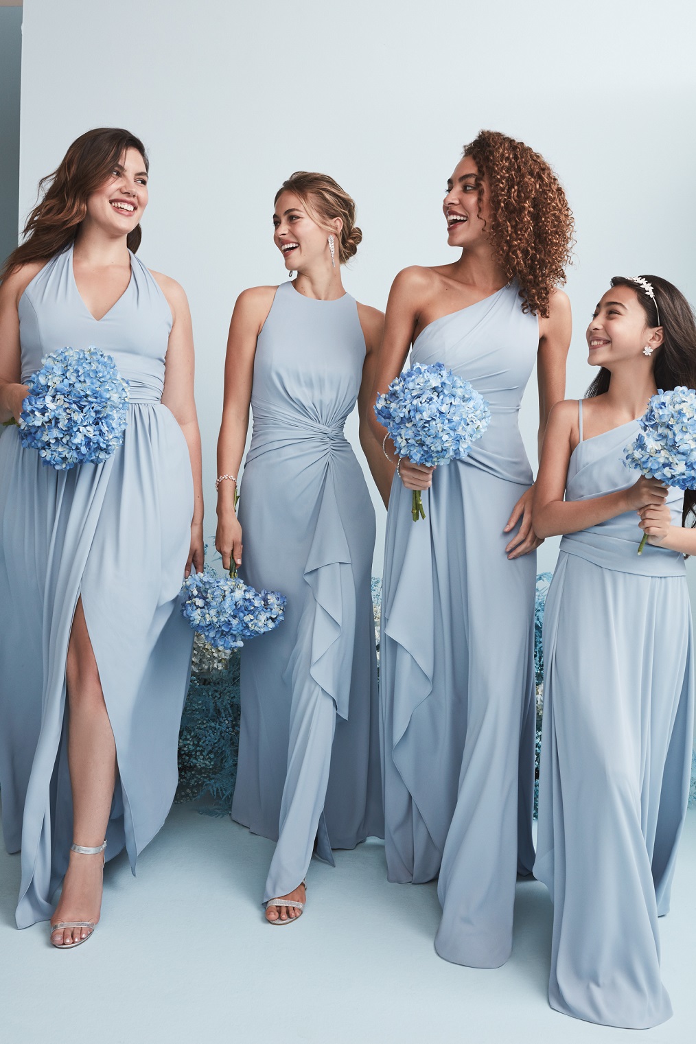 Four bridesmaids in long dusty blue bridesmaid dresses