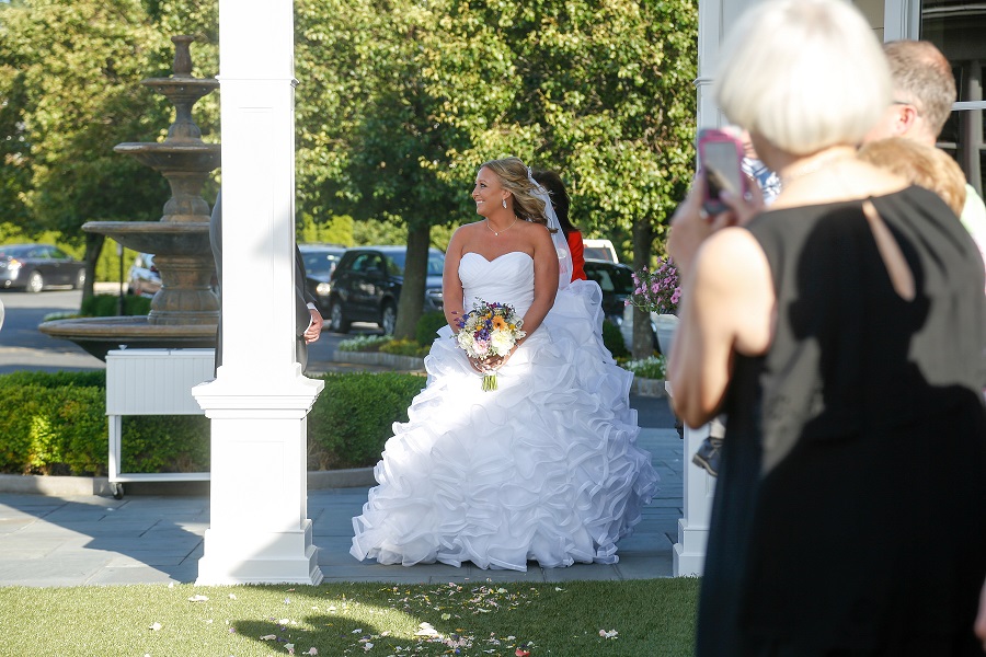 Solo shot of bride walking in to the ceremony