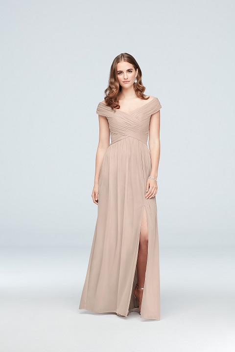 Bridesmaid in long neutral dress with off the shoulder neckline and slit