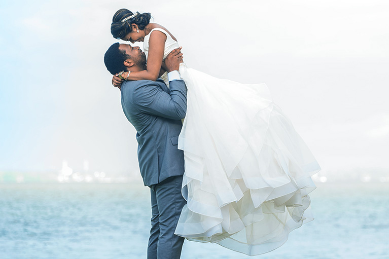 Groom Lifting Bride in two-piece ball gown dress