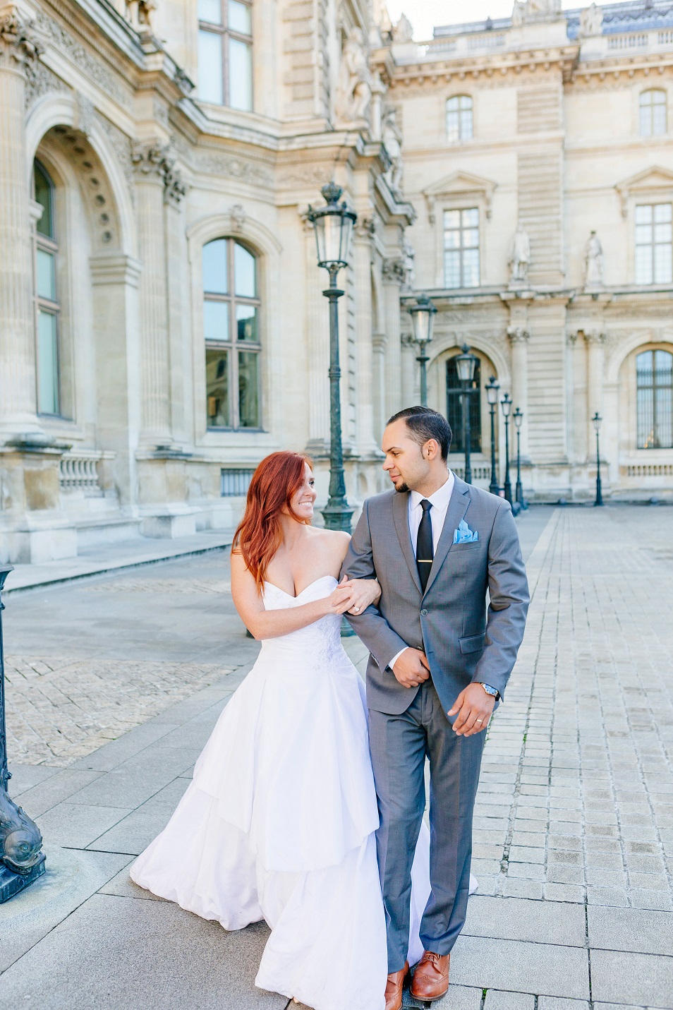 Bride Emily and Groom TJ hold hands in Paris.