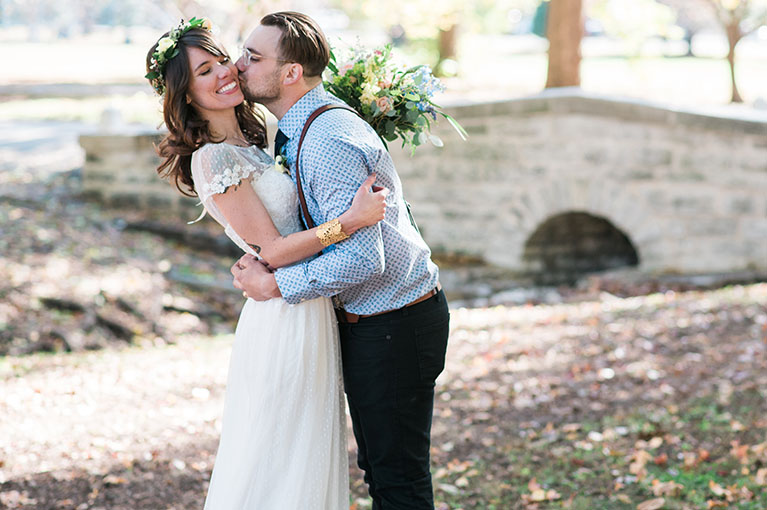 Bride and groom embracing during their outdoor wedding ceremony