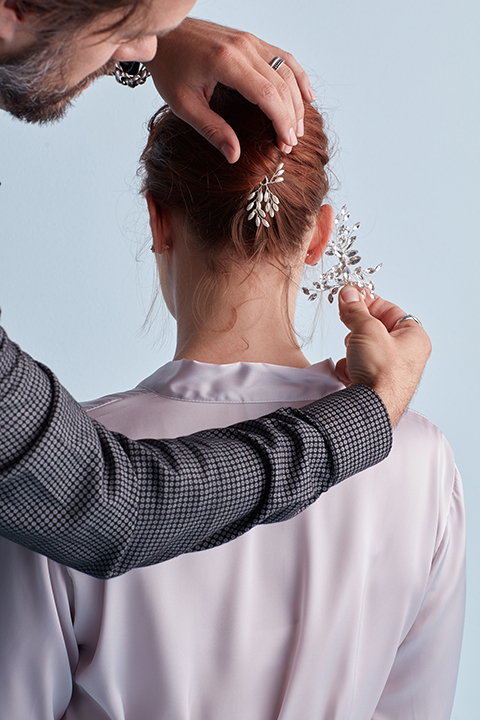 Hair stylist adding pins to twisted hairstyle