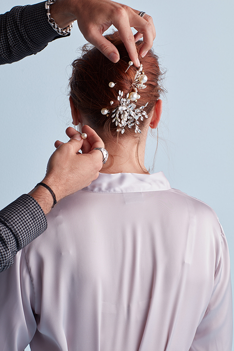 Hair stylist adding pins to twisted hairstyle