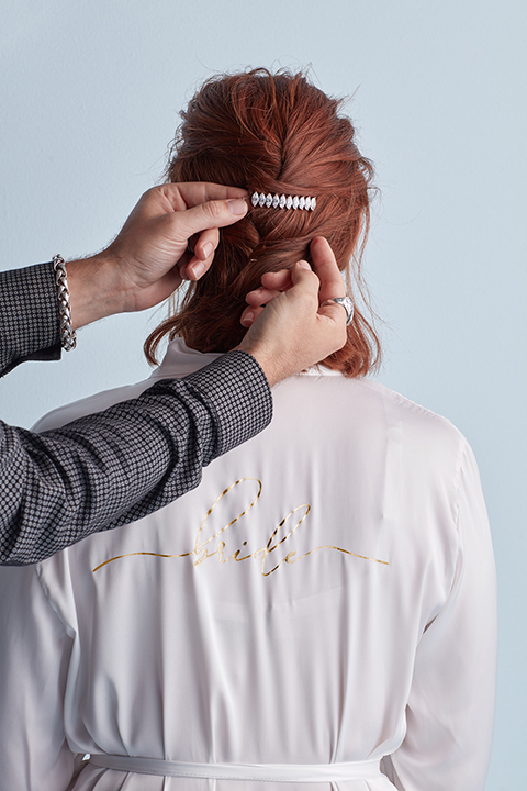 Hair stylist adding clip to hair