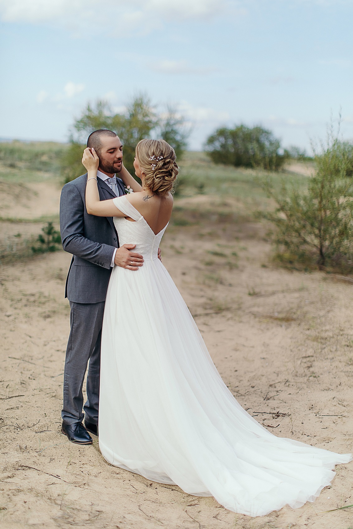 Bride Anna and Groom Levan share a first look moment showcasing the back of the bride's dress