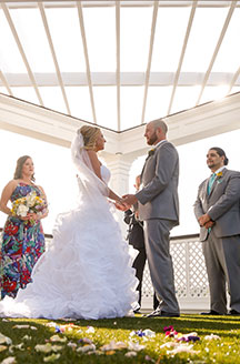 Bride and groom holding hands at the ceremony