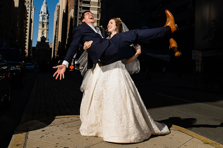  Bride and groom laughing as bride carries groom