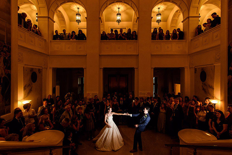 Bride and groom dancing in a dimly lit ballroom