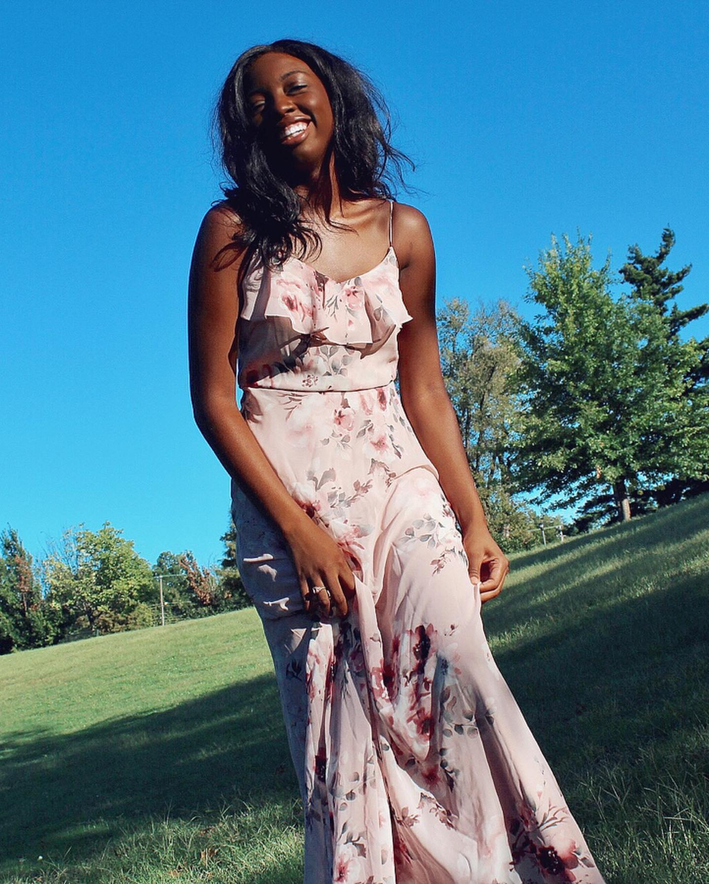 girl in long pink dress with floral print