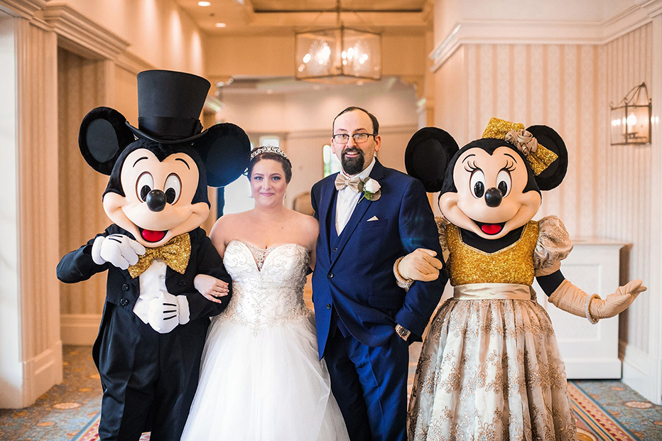 Real Weddings Couple Katie and Shane posing with Mini and Micky Mouse.