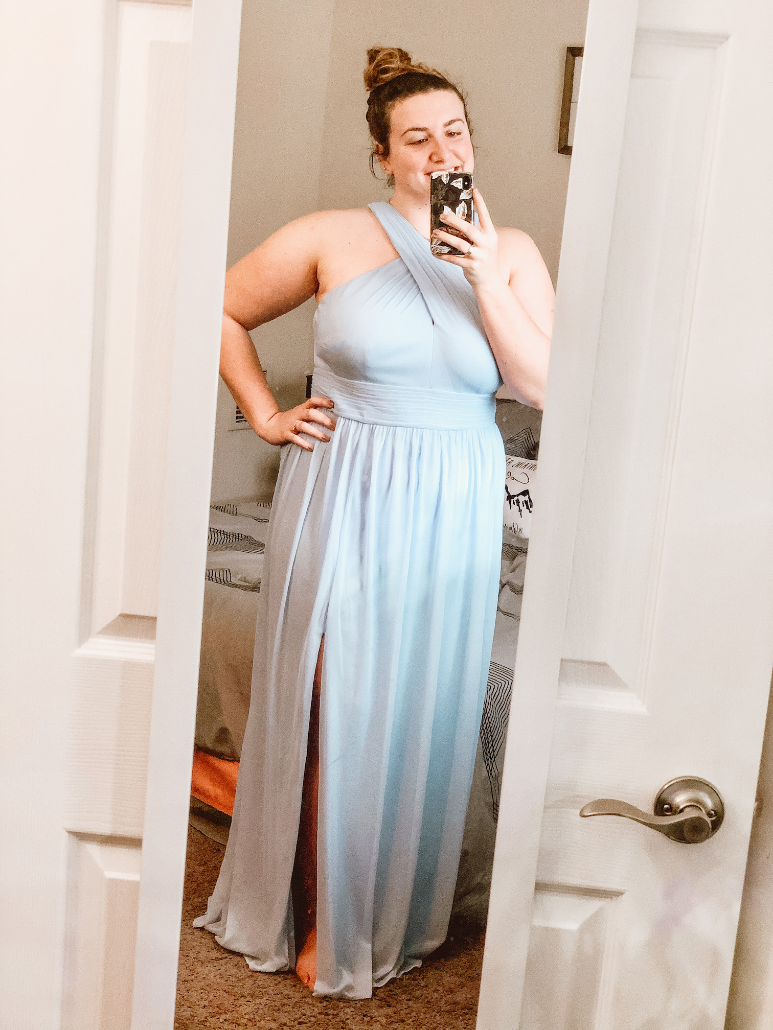 Bridesmaid trying on dress looking in mirror