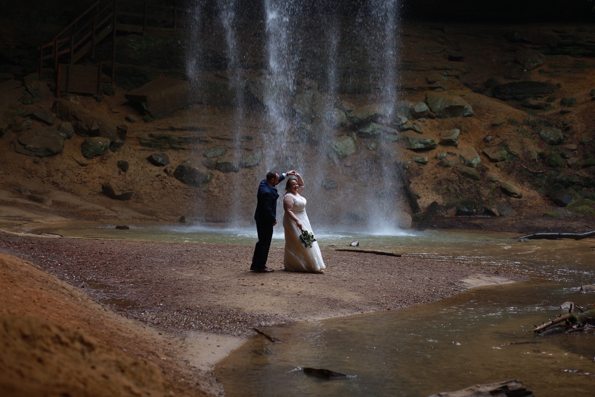 Bride and Groom Dancing under Waterfall

