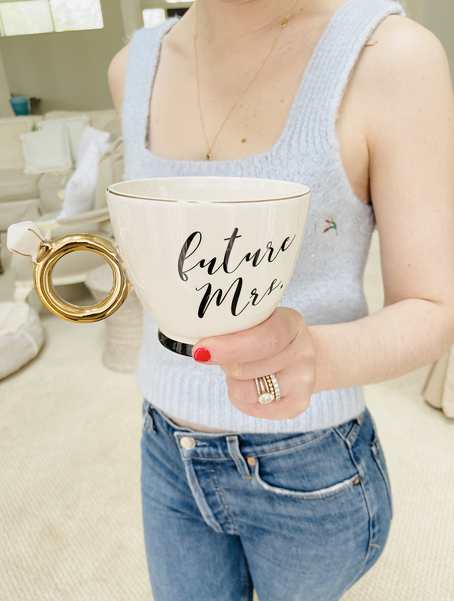 Bride to be holding her Future Mrs. Mug at home.