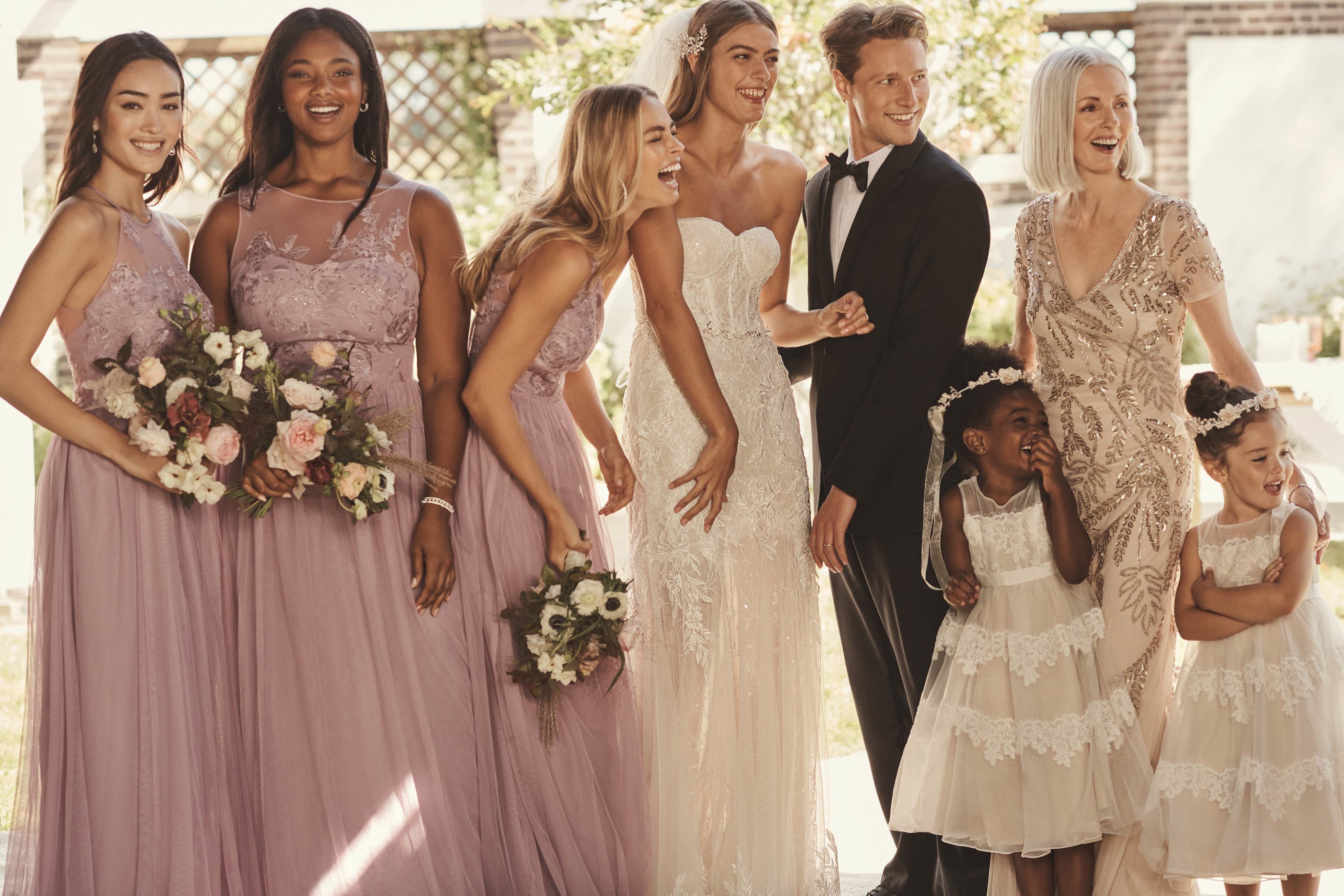 Full bridal party featuring lavender haze bridesmaid dresses