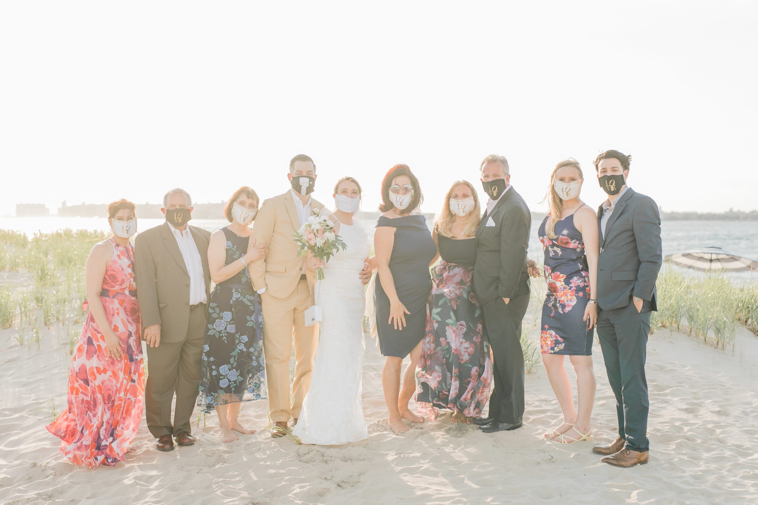 Bride and Groom + family picture on beach