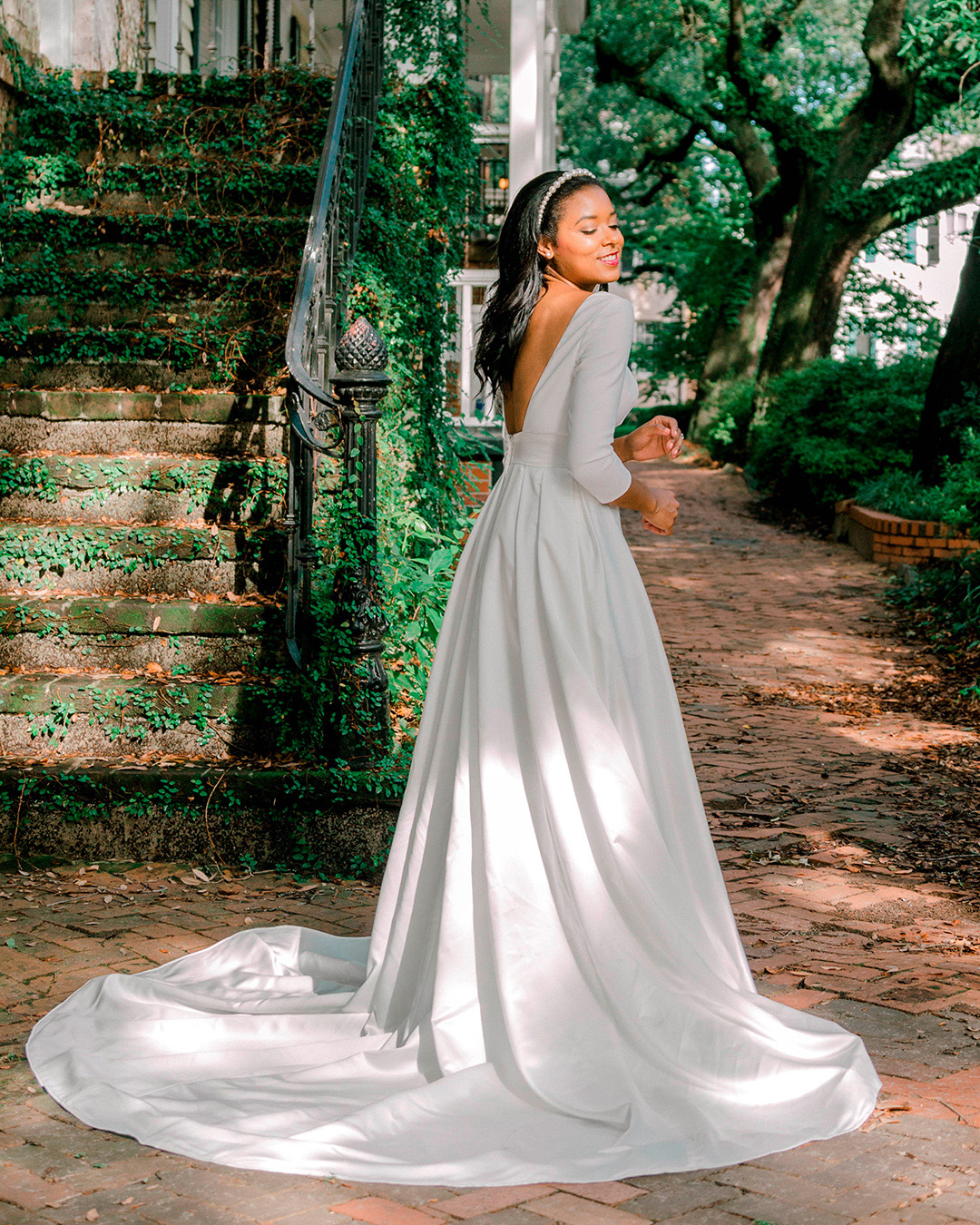 bride in long sleeve modern wedding dress with train
