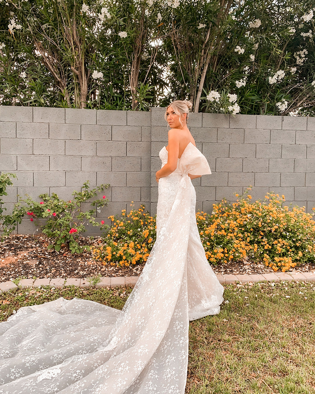 bride in lace wedding dress with dramatic bow train